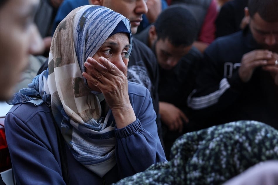 A Palestinian woman reacts in front of the bodies people killed in an Israeli strike, at the al-Aqsa Martyrs Hospital in Deir Al-Balah in the central Gaza Strip on November 17, 2024.