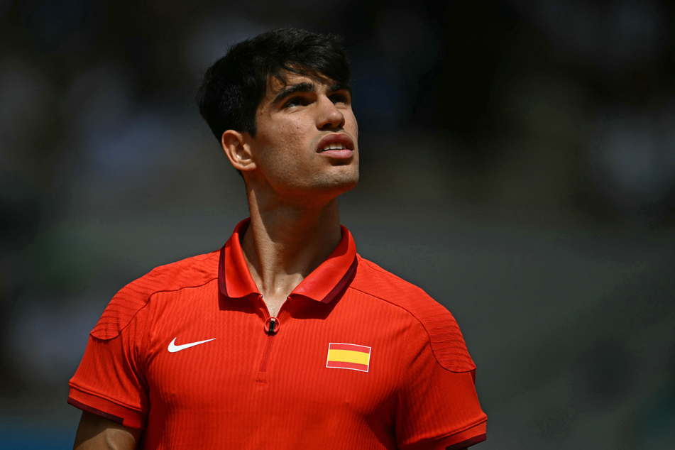 Spain's Carlos Alcaraz reacts while playing against Serbia's Novak Djokovic during their men's singles final tennis match on Court Philippe-Chatrier at the Roland-Garros Stadium during the Paris 2024 Olympic Games, in Paris on Sunday.