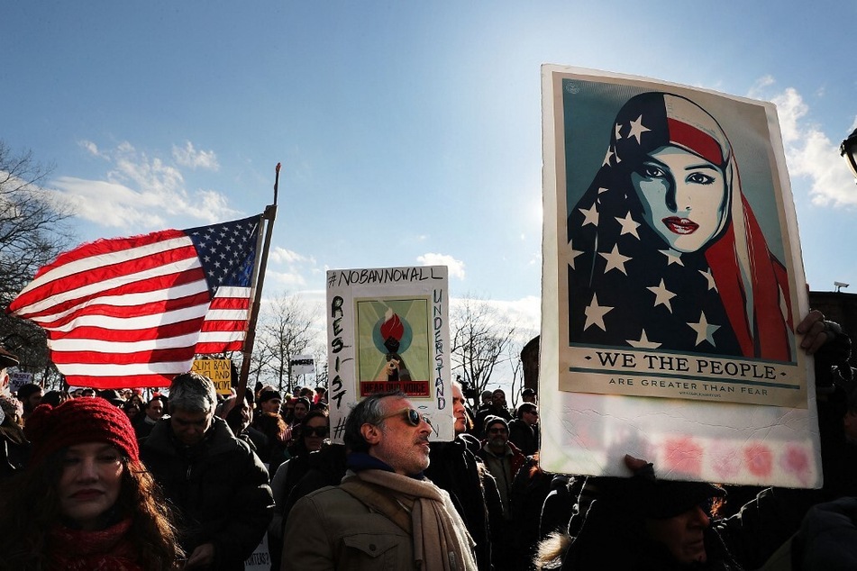 Demonstrators rally in New York City's Battery Park to protest Donald Trump's Muslim Ban, enacted in 2017.