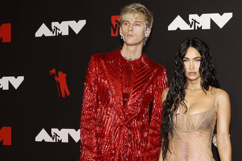 On Sunday, Megan Fox (r) dished that her barely-there dress was all thanks to Machine Gun Kelly (l).