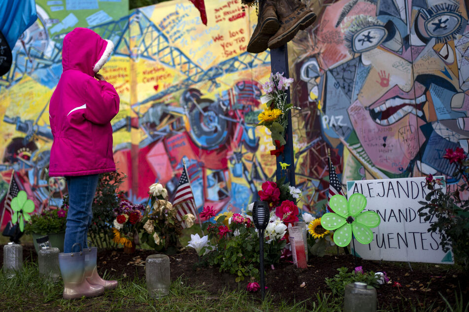 People visit a memorial to honor the six men killed in the collapse of the Francis Scott Key Bridge in Baltimore, Maryland, on May 12, 2024.