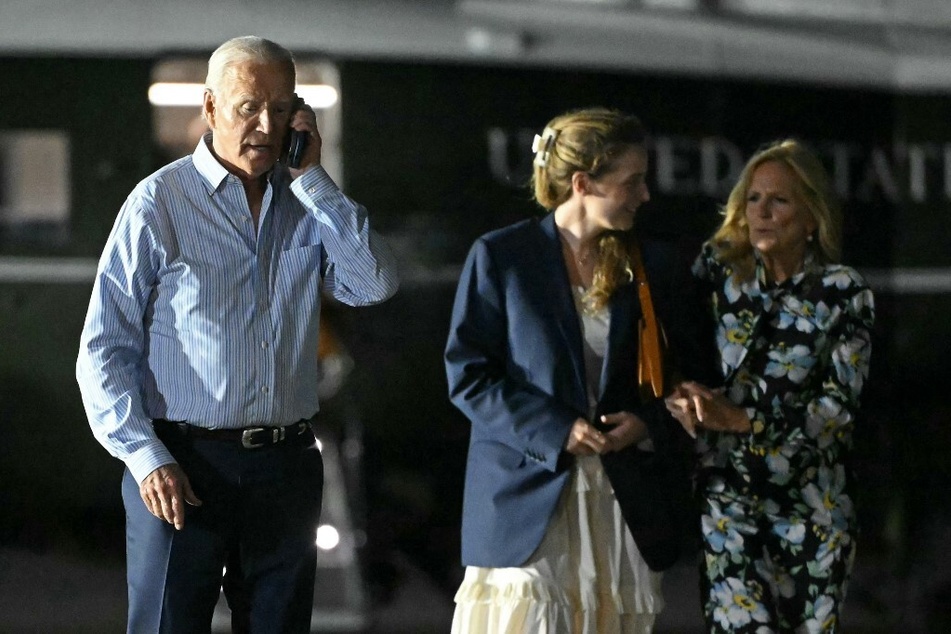 President Joe Biden and First Lady Jill Biden, alongside granddaughter Finnegan, prepare to board Air Force One, bound for the Camp David presidential retreat.