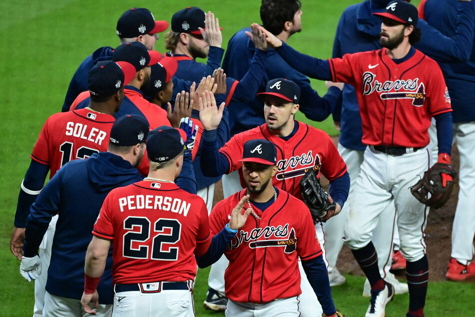 The Braves celebrate after defeating the Astros in game three of the World Series.