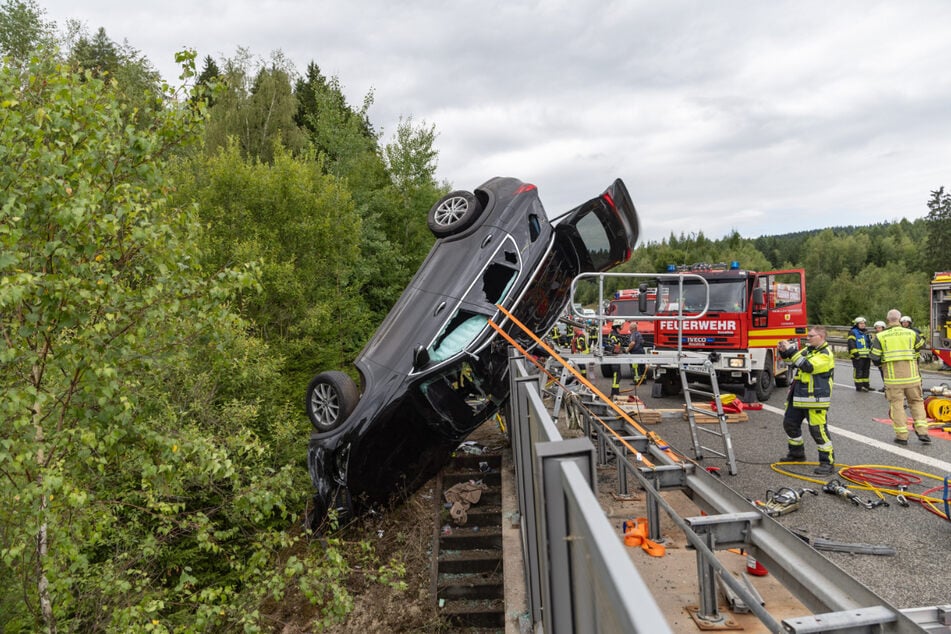Das Auto blieb an dem Brückengeländer hängen.