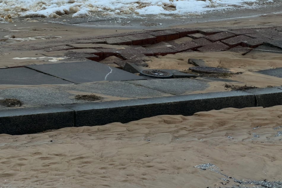 Das Wasser unterspülte die Straße und ließ Teile des Gehwegs einsacken.