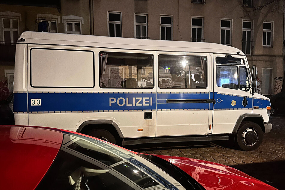 Ein Einsatzfahrzeug der Polizei steht bei einer Razzia in Berlin-Friedrichshain auf der Straße.