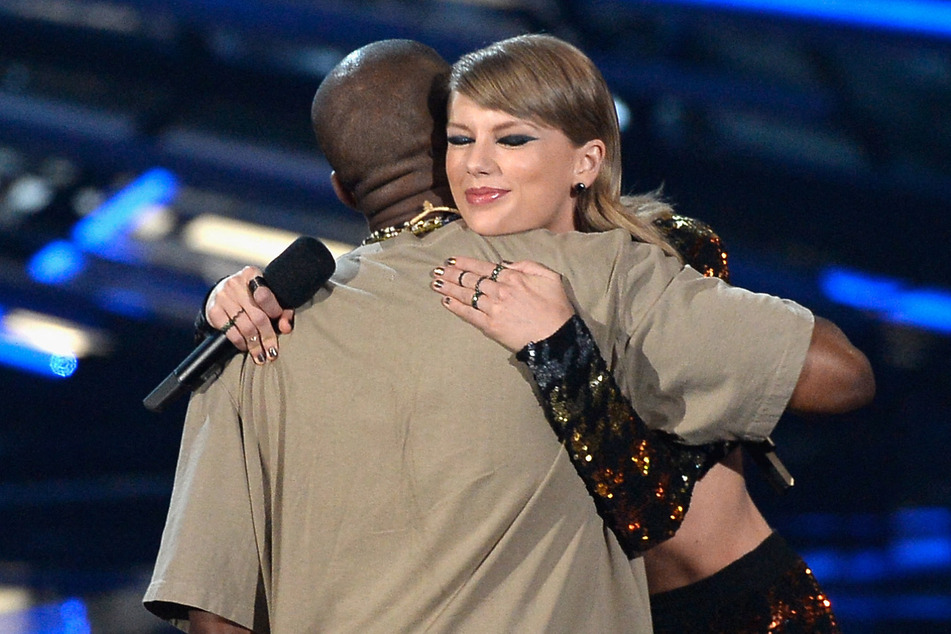 Kanye West accepting the Video Vanguard Award from Taylor Swift onstage during the 2015 MTV Video Music Awards on August 30, 2015.