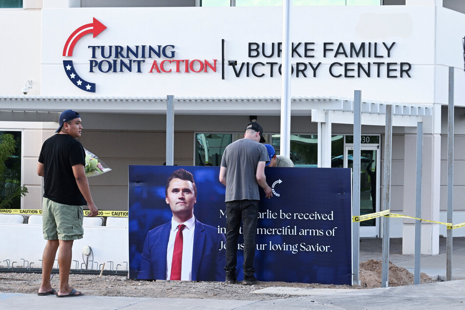 Mourners bring flowers to a memorial for Charlie Kirk outside Turning Point in Phoenix, Arizona.