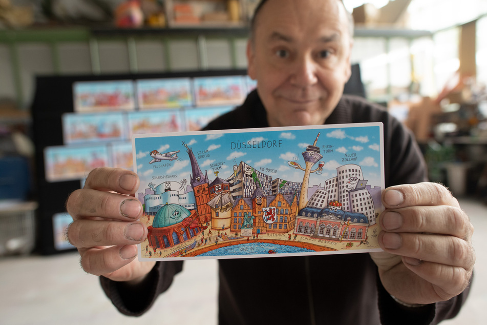 Karnevalswagenbauer Jacques Tilly (57) hat 27 Städte humoristisch porträtiert. Die Bilder sollen demnächst als Postkartenmotive in Bahnhöfen verteilt werden.