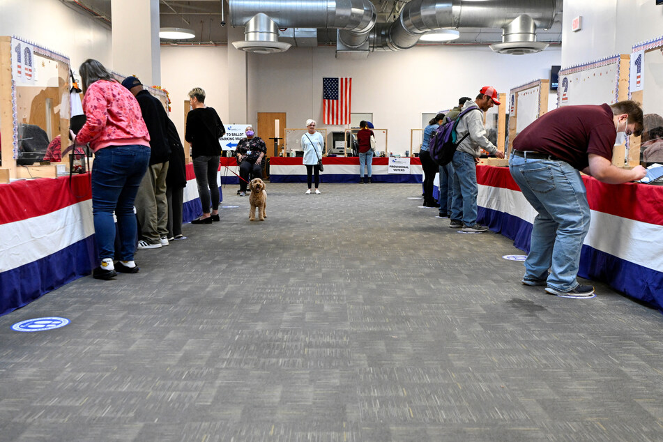 Voters check in to cast their early ballot for the 2022 midterm elections in Columbus, Ohio.