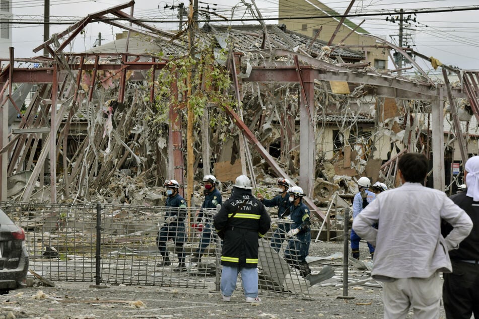 Rettungskräfte und Ermittler arbeiten in der Nähe des explodierten Gebäudes in der japanischen Stadt Koriyama.