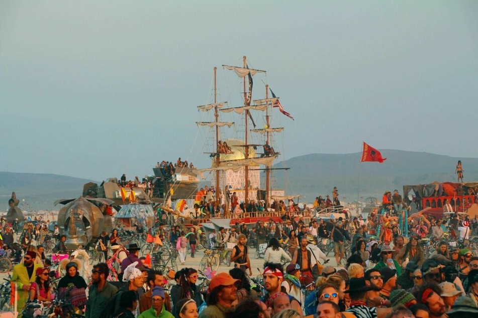 Burners gather for the sunset on the playa during the 2014 Burning Man festival (archive image).