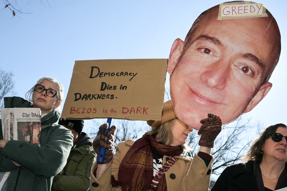 Hundreds of people protested outside the headquarters of The Washington Post after the storied newspaper announced sweeping job cuts.