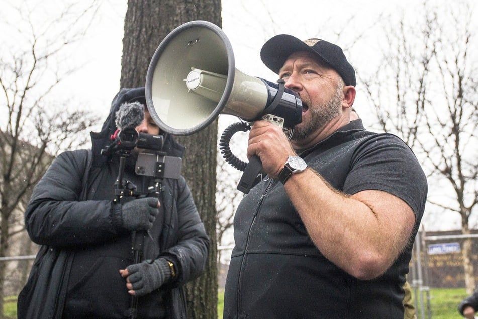 Conspiracy theorist Alex Jones is suing The Onion and families of the Sandy Hook victims in an effort to win back his recently auctioned-off Infowars show.