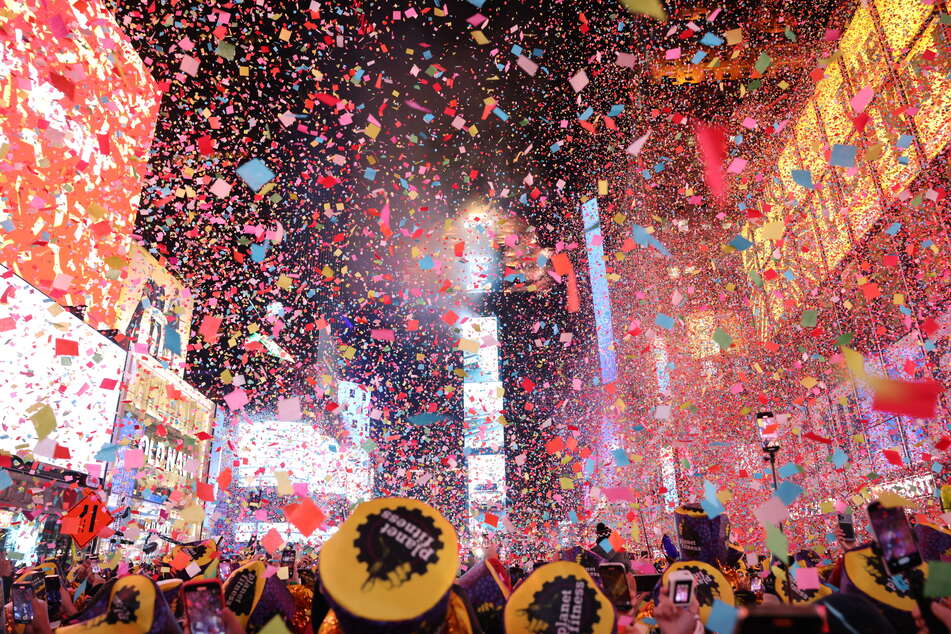 Confetti falls at a New Year's celebration in New York City's Times Square as hundreds of thousands of people welcome 2023.