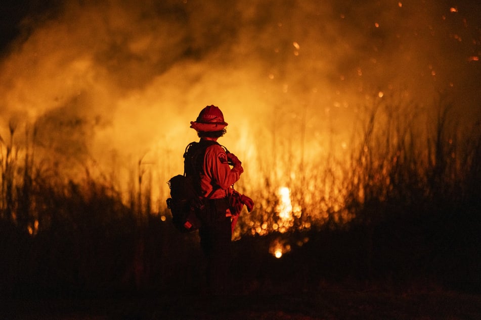 A firefighter monitors the spread of the Auto Fire in Oxnard, northwest of Los Angeles, California, on Monday.