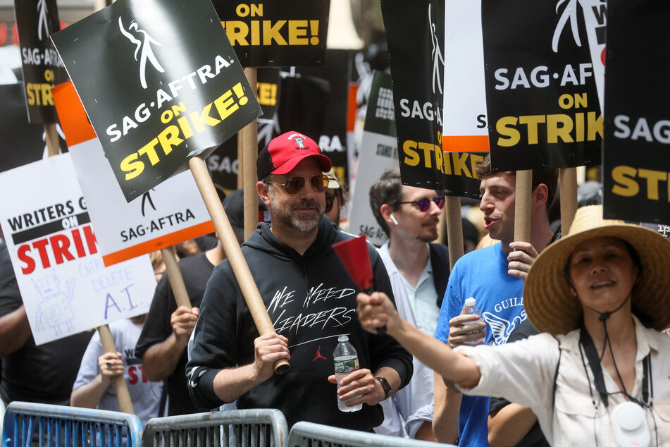 Ted Lasso star Jason Sudeikis (c.) joined the picket lines in New York as TV and movie production ground to a halt amid the biggest strike in decades.