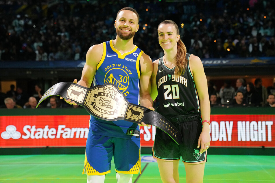 Golden State Warriors guard Stephen Curry and New York Liberty guard Sabrina Ionescu after the Stephen vs Sebrina three-point challenge during NBA All Star Saturday Night at Lucas Oil Stadium.