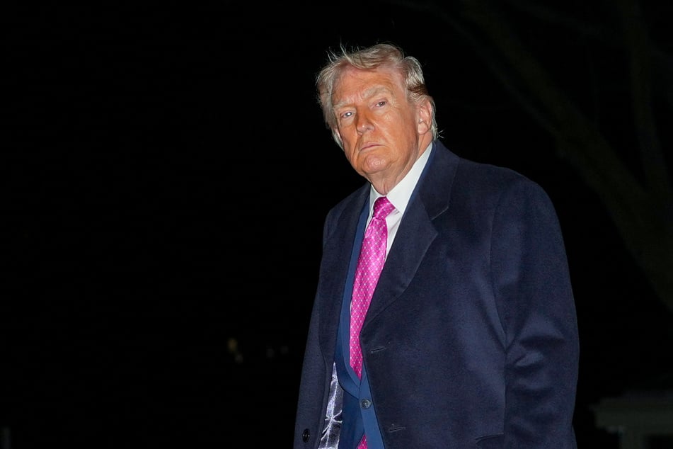 President Donald Trump walks on the South Lawn upon returning to the White House in Washington DC on March 29, 2026.