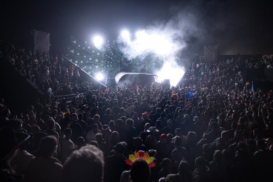 Festivalgoers dance as Ukranian DJ Daria Kolosova performs at The Temple stage at the end of the Glastonbury festival at Worthy Farm in the village of Pilton in Somerset, southwest England, on Monday.