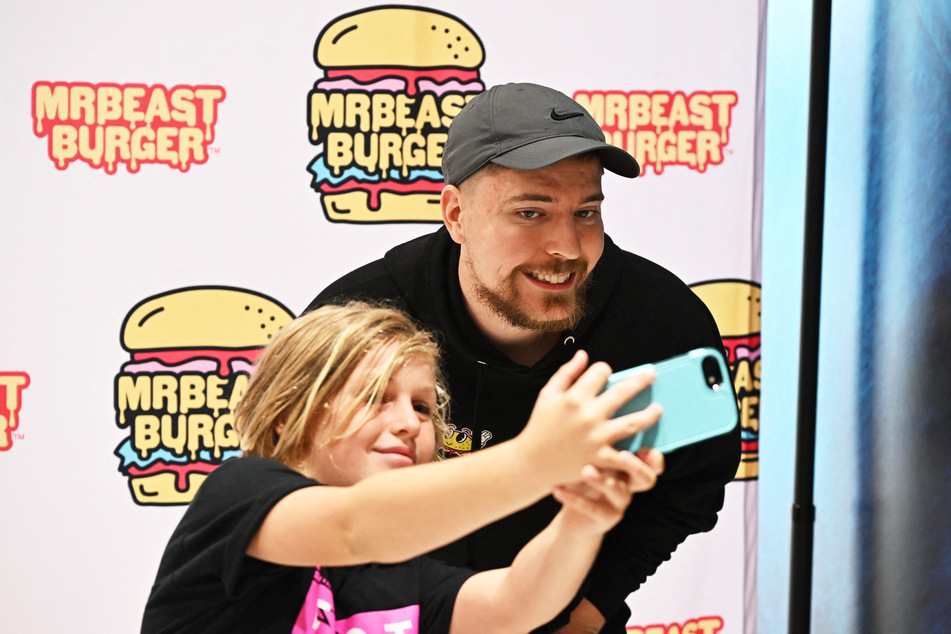 MrBeast poses with fan at the launch of the first physical MrBeast Burger Restaurant at American Dream Mall in New Jersey on September 4, 2022.