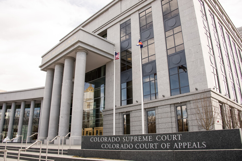 A man broke into the Colorado Supreme Court building overnight, firing several shots and briefly holding a security guard at gunpoint before being arrested, local police said Tuesday.
