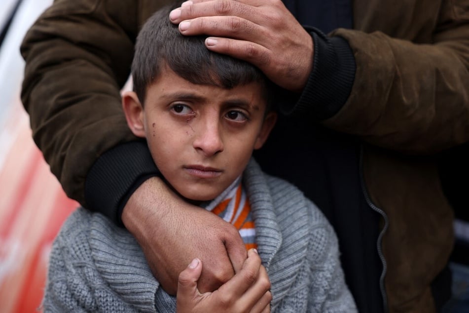 A Palestinian boy mourns the death of a loved one killed an Israeli strike the previous night, outside Nasser Hospital in Khan Younis in the southern Gaza Strip, on January 16, 2025.