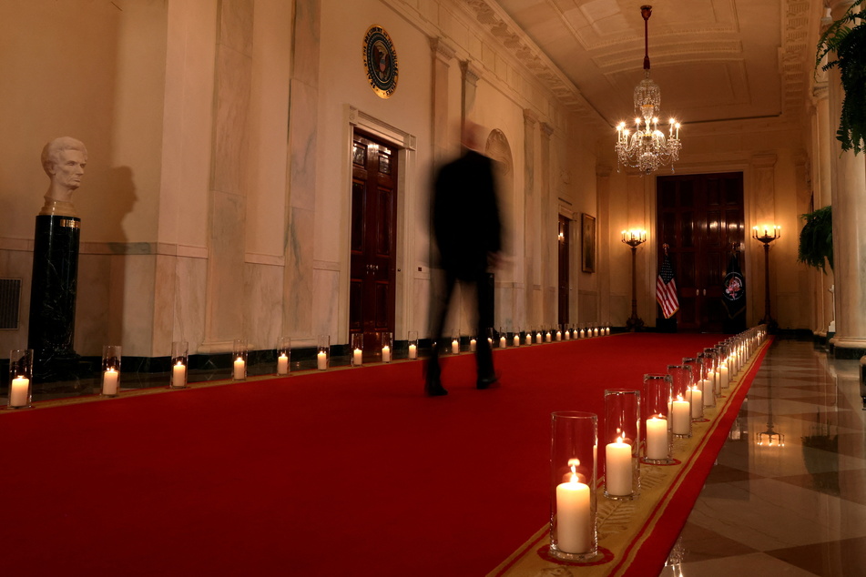 The White House cross hall was lined with 56 candles memorializing shooting victims in all states and territories.