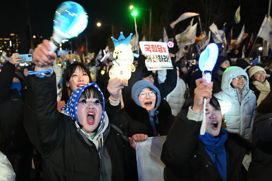 Protesters take part in a rally near the National Assembly in Seoul on December 3, 2025, to mark the first anniversary of the declaration of martial law by ousted president Yoon Suk Yeol.