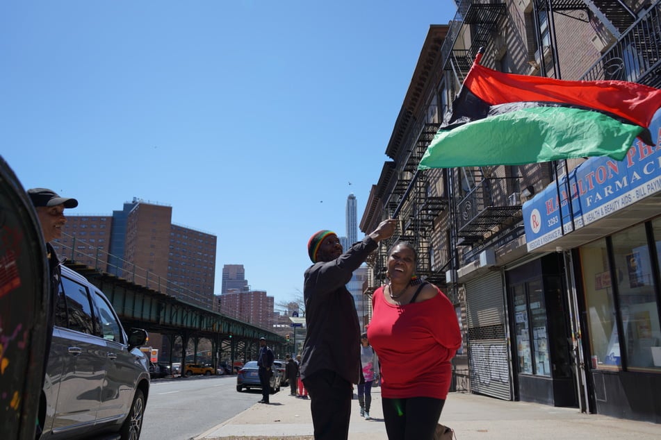 Attendees of the fourth session of the United Nations Permanent Forum on People of African Descent in New York City raise a Pan-African flag amid overwhelming calls for reparations.