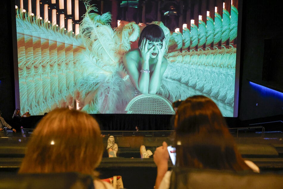 Audience members watch a film screening during Fans Celebrate The Theatrical Release Of Taylor Swift: The Official Release Party Of A Showgirl at Westfield Century City in Los Angeles, California, on October 3, 2025.