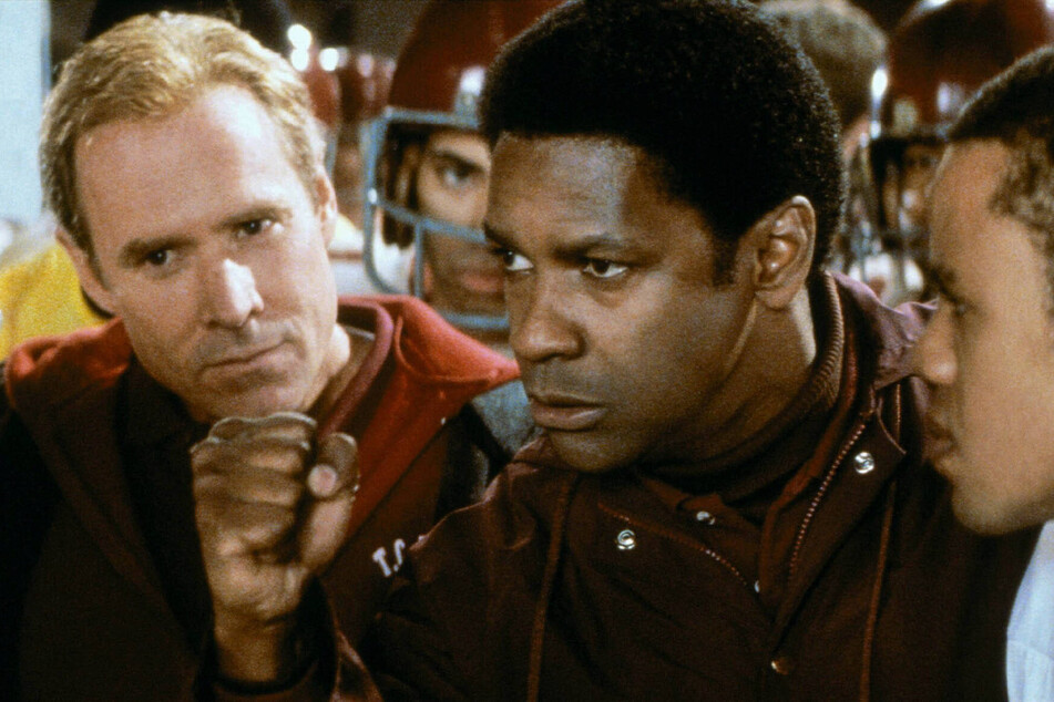 Denzel Washington (r) and Will Patton play high school coaches who work together to blend a racially divided football team in the biographical drama, Remember The Titans.
