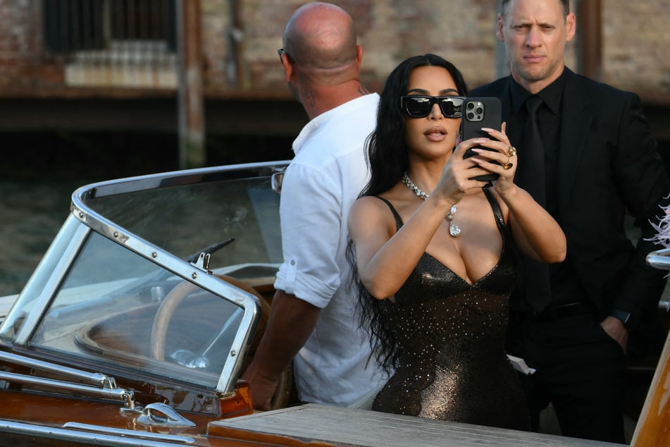 Kim Kardashian (c.) flashed the rarely-seen lip tattoo while appearing on the Tonight Show with Jimmy Fallon.