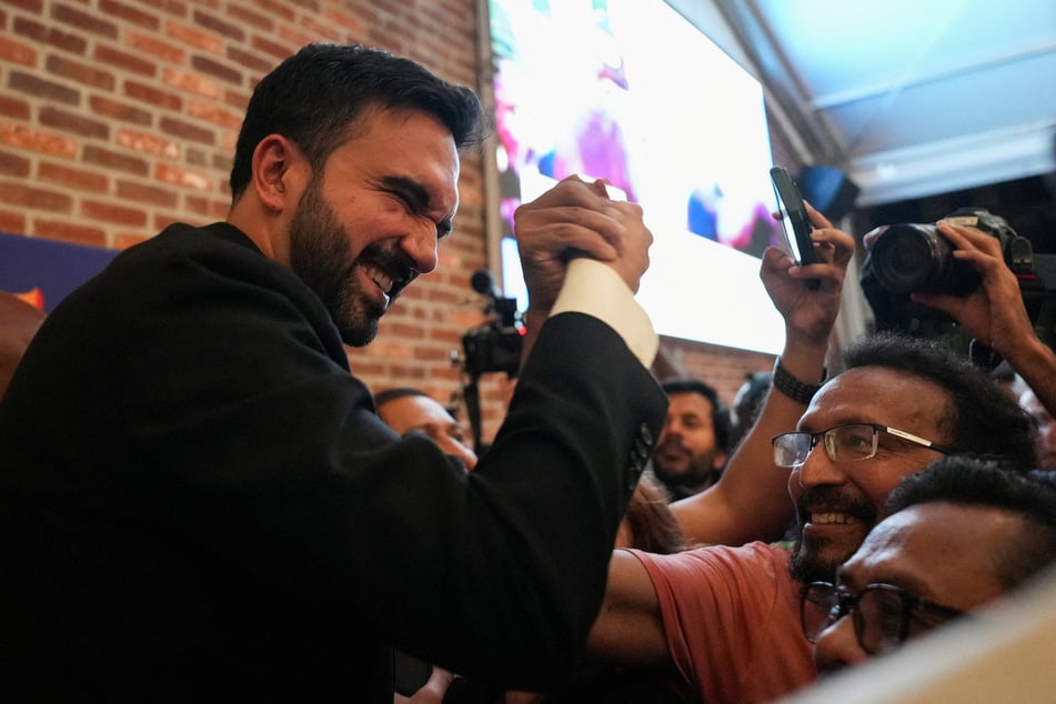 Zohran Mamdani (l.) greets a supporter during a watch party for his New York City Democratic mayoral primary election on June 25, 2025.