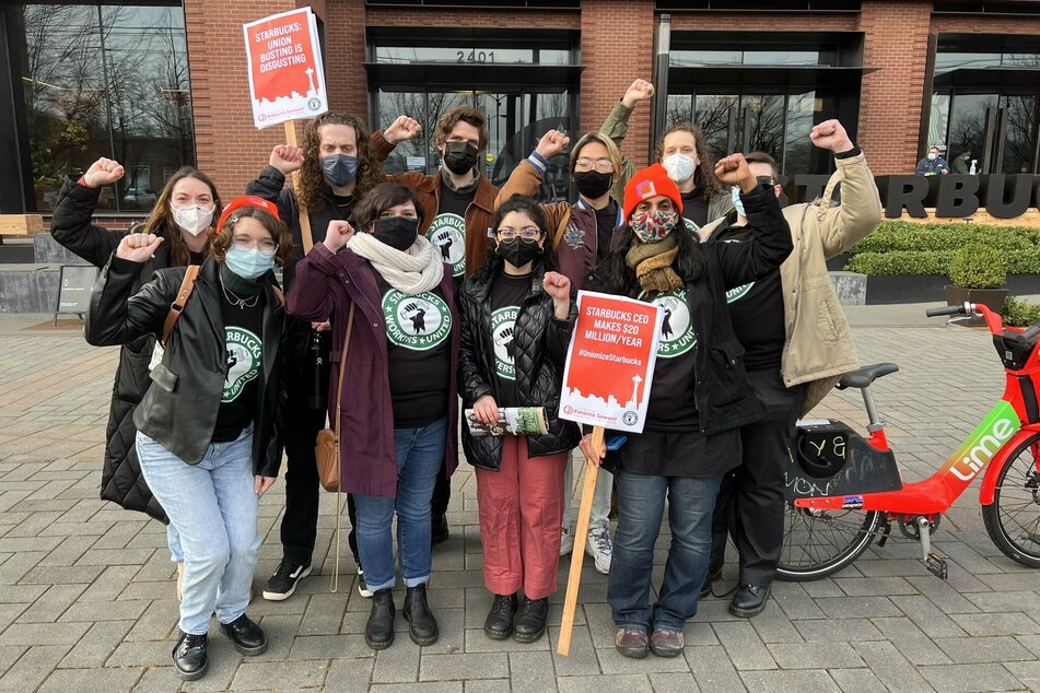 Seattle City Council Member Kshama Sawant (front r.) joins Starbucks workers at a rally outside the coffee company's corporate headquarters.