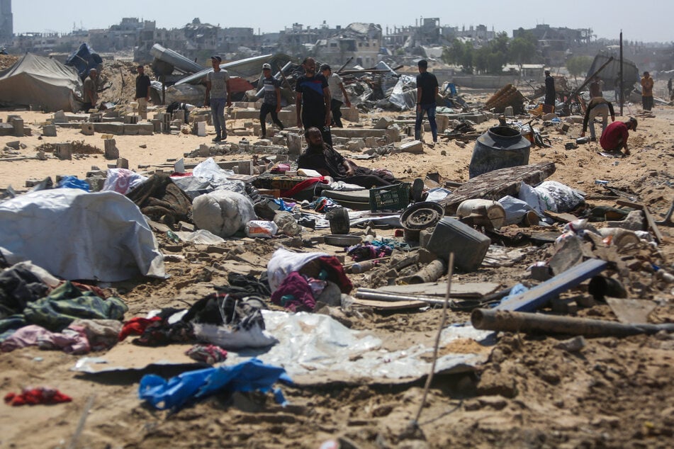 Palestinians inspect the destruction at a makeshift displacement camp following a reported incursion a day earlier by Israeli tanks in the area in Khan Yunis in the southern Gaza strip on July 11, 2025.