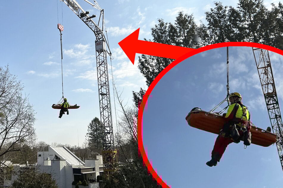 Höhenretter der Feuerwehr begleiteten den Patienten in einer Trage auf den Boden.