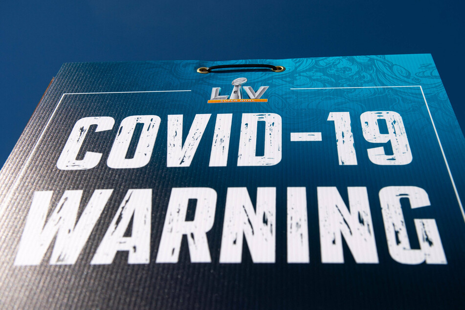 A Covid-19 warning sign outside of Raymond James Stadium prior to Super Bowl LV in Tampa, Florida.