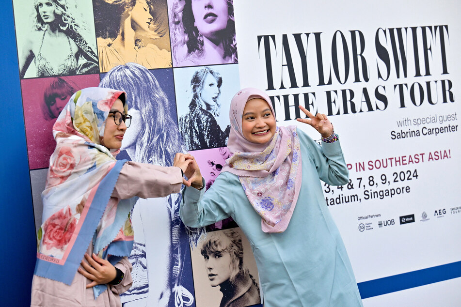 Swifties pose for a picture at the National Stadium during Taylor Swift's The Eras Tour concert in Singapore.