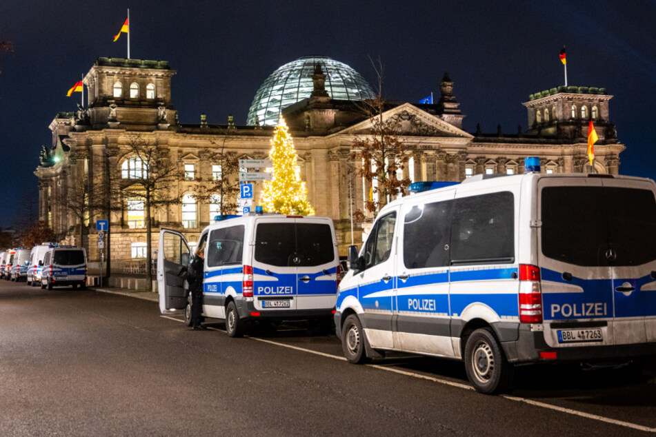 Vor dem Reichstagsgebäude stehen Polizeiautos. Das Regierungsviertel ist komplett abgesperrt.