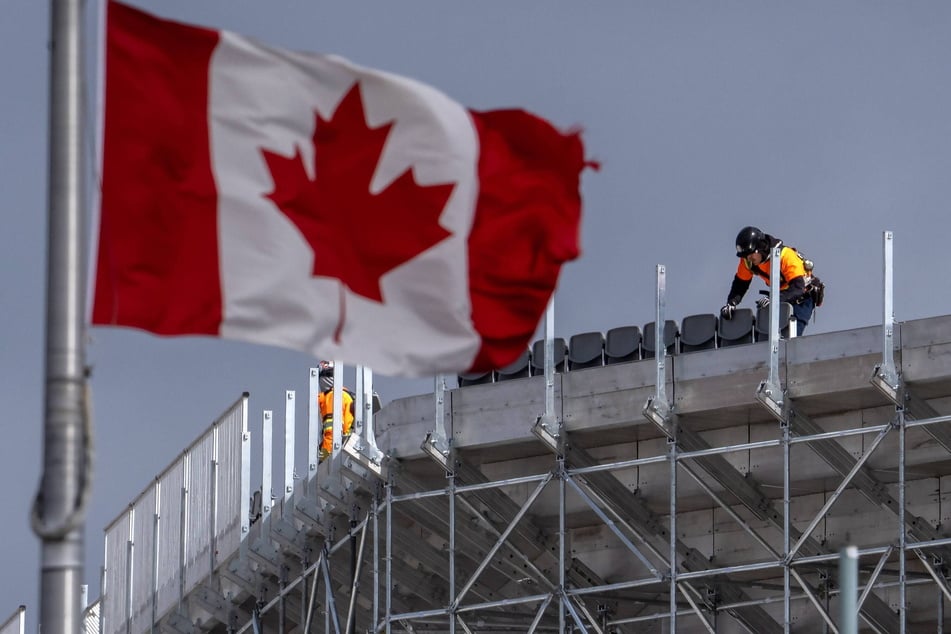 Workers assemble temporary seating high in the air for the FIFA World Cup at BMO Field in Toronto, Canada, on March 12, 2026.