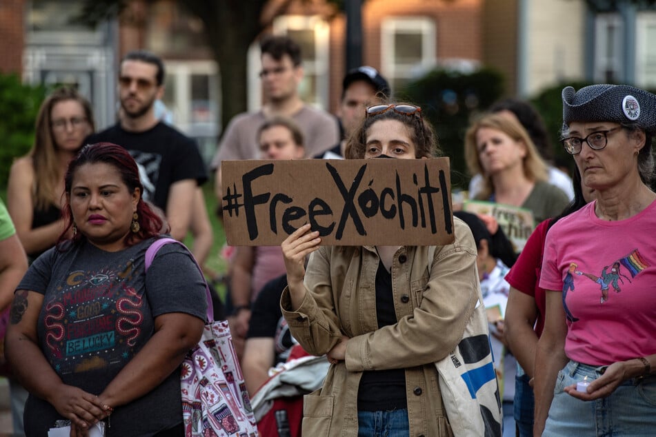 A protester holds a sign during a vigil calling for the release of Catalina "Xóchitl" Santiago and others detained by ICE in Boston, Massachusetts, on August 24, 2025.