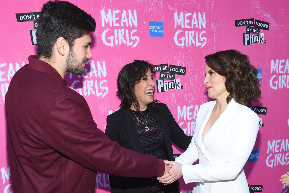 Rosalind Wiseman (c.), whose book inspired the 2004 classic Mean Girls, is considering legal action against Tina Fey (r.) and Paramount Studios over "unpaid dues."