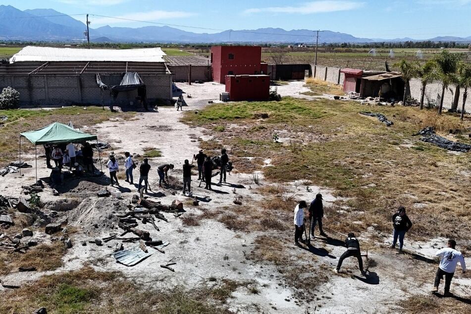 Members of the collective Guerreros Buscadores work at the Izaguirre Ranch in the community of La Estanzuela, where they located three human crematoriums while searching for their relatives in Teuchitlan, Mexico.