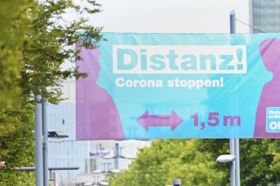 Ein großes Plakat mit der Aufschrift "Distanz ! Corona stoppen !" prangte im August 2020 am Ortseingang von Offenbach.