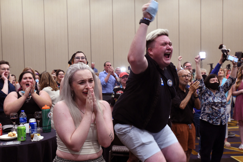 Abortion supporters Alie Utley and Joe Moyer react to the failed constitutional amendment proposal at the Kansas Constitutional Freedom Primary Election Watch Party in Overland Park, Kansas, on August 2, 2022.