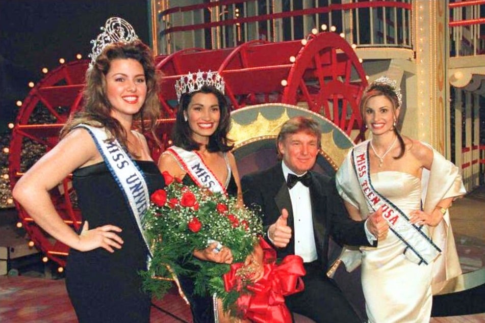 Donald Trump, Executive Producer of the 1997 Miss USA Pageant, posing with contestants at the Hirsch Coliseum in Shreveport, Louisiana on February 5, 1997.