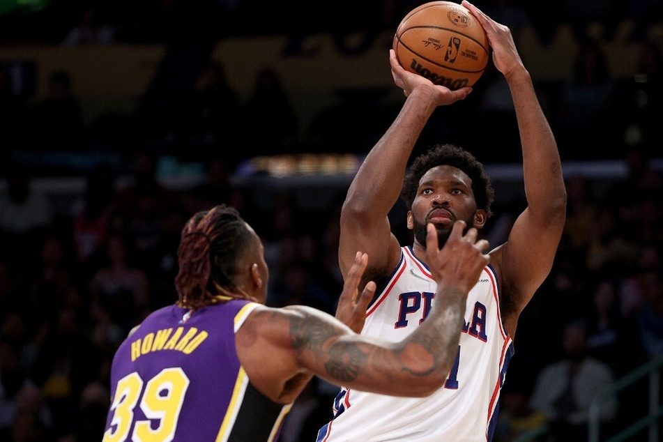 Joel Embiid of the Philadelphia 76ers scores on a jumper over Dwight Howard of the Los Angeles Lakers.