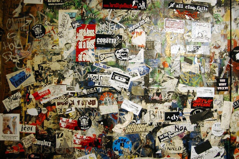 Thirty years of band stickers adorn the walls of CBGB in New York City.
