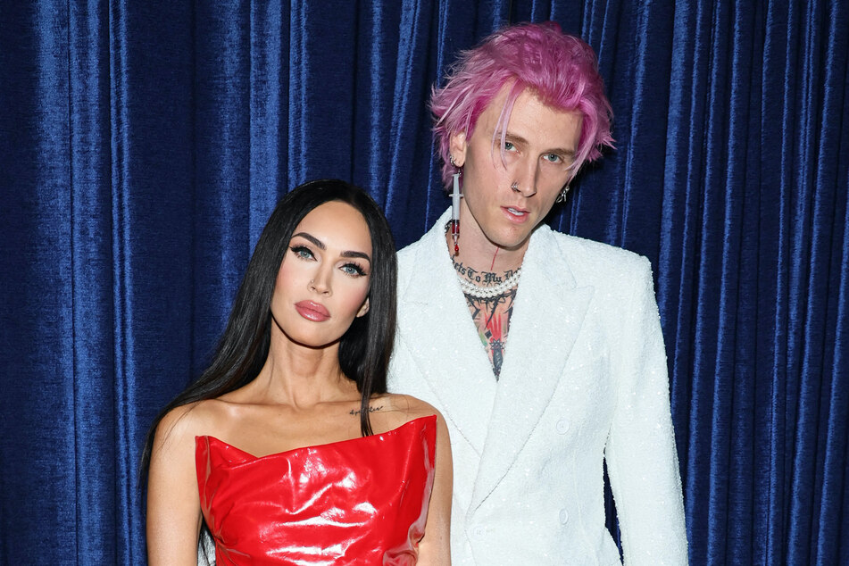 Insiders dish that Megan Fox (l.) and MGK are focused on working on their romance, but their wedding plans are currently on pause.